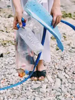 image showing someone holding some pieces on a beach that could have been recycled